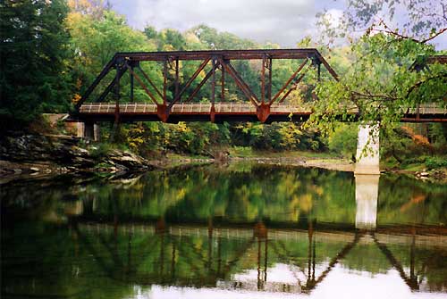Find the old railroad bridge and swimming hole along the river.